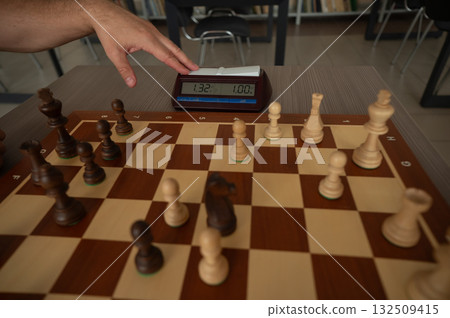 A man switches a chess clock. A man switches a chess clock. 132509415