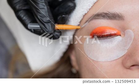 Caucasian woman undergoing eyelash lamination procedure. Caucasian woman undergoing eyelash lamination procedure. 132509453