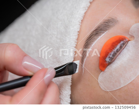 Caucasian woman undergoing eyelash lamination procedure. Caucasian woman undergoing eyelash lamination procedure. 132509456