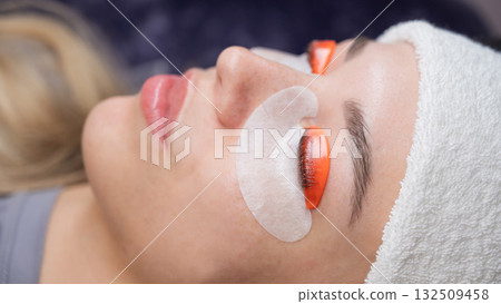 Caucasian woman undergoing eyelash lamination procedure.  132509458