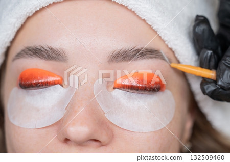 Caucasian woman undergoing eyelash lamination procedure. Caucasian woman undergoing eyelash lamination procedure. 132509460