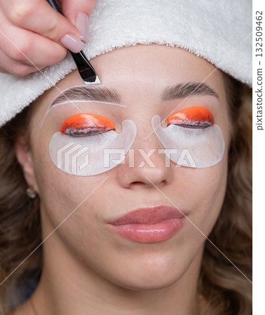 The process of professional lamination and dyeing of eyelashes and eyebrows in the salon.  132509462