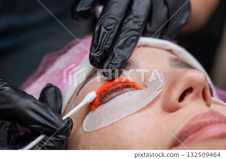 Caucasian woman undergoing eyelash lamination procedure.  132509464