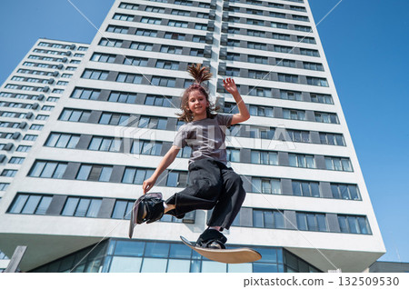 Girl practices skiing tricks on a trampoline. Girl practices skiing tricks on a trampoline. 132509530