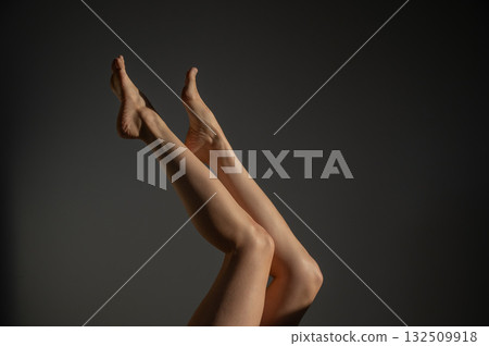 Woman applying moisturizer to her legs.  132509918