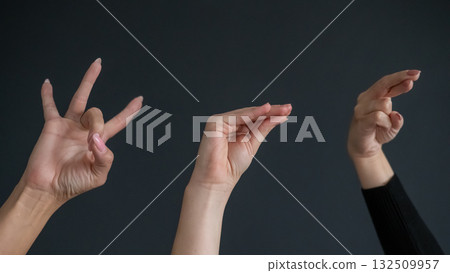 Russian Sign Language. Close-up of hands on black background. Russian Sign Language. Close-up of hands on black background. 132509957