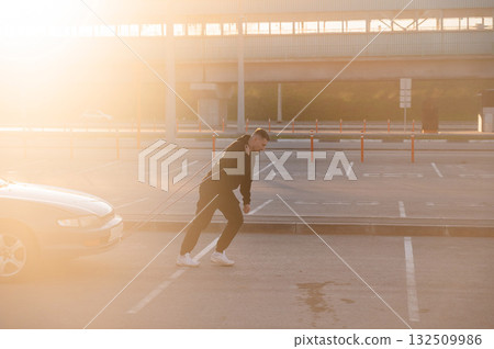 Caucasian man pulling a car with a rope. Caucasian man pulling a car with a rope. 132509986