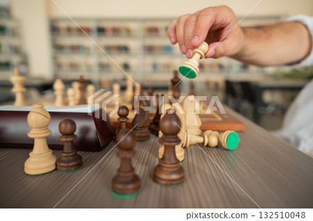 Close up of hands of middle aged caucasian man playing chess. Close up of hands of middle aged caucasian man playing chess. 132510048