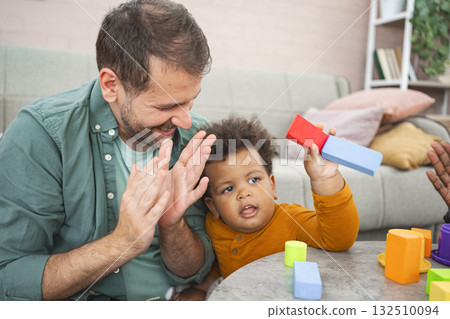 Multiracial family plays with colorful building blocks Multiracial family plays with colorful building blocks 132510094