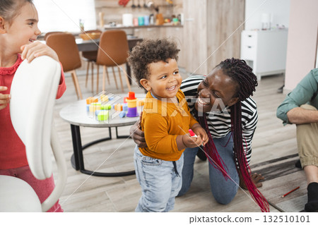Joyful multiracial family playing together at home during the day Joyful multiracial family playing together at home during the day 132510101