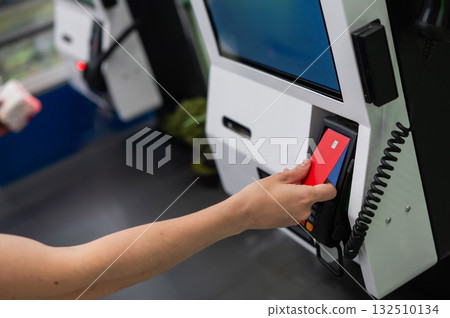 Woman paying with credit card at self-checkout. Woman paying with credit card at self-checkout. 132510134