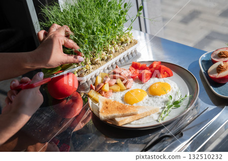 Chef serves fried eggs in a cafe. Chef serves fried eggs in a cafe. 132510232