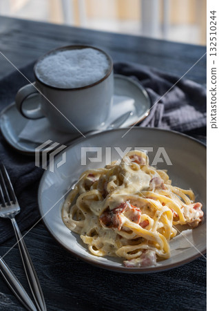 Pasta carbonara served in a cafe. Pasta carbonara served in a cafe. 132510244