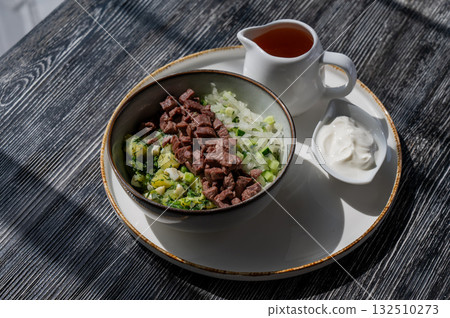 Okroshka with beef on kvass in a cafe. Okroshka with beef on kvass in a cafe. 132510273