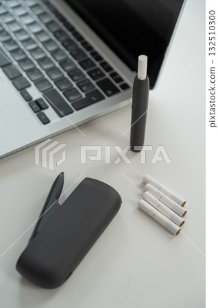 Tobacco heating system next to a laptop.  132510300