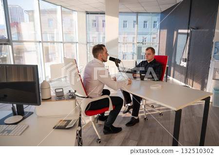 Two Caucasians Recording an Audio Podcast. Two Caucasians Recording an Audio Podcast. 132510302