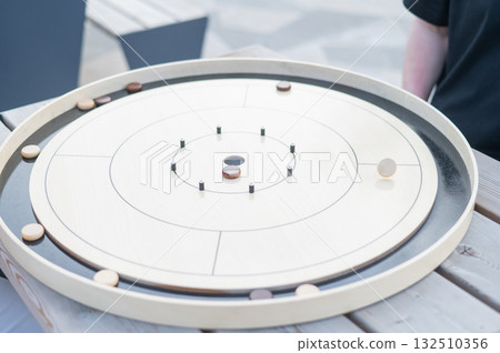 Strategic Game Pieces on a Wooden Board crokinole.  132510356