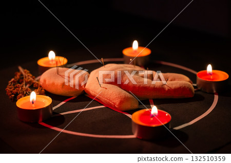 Voodoo doll on a pentagram. Witch spells. 132510359