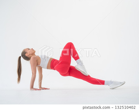 Caucasian woman doing sports exercises on white background.  132510402