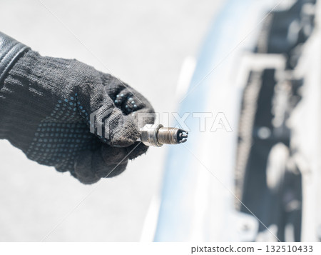 Caucasian man changing spark plugs in car. Caucasian man changing spark plugs in car. 132510433