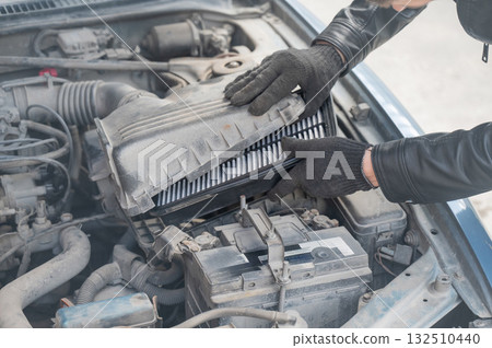 Mechanic changing the air filter.  132510440