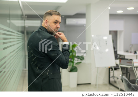 Caucasian man in dirty jacket in office. Caucasian man in dirty jacket in office. 132510442