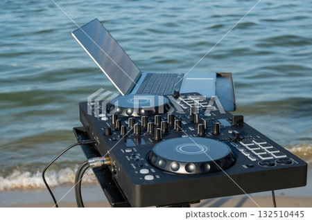 Close up of DJ's hands while working outdoors.  132510445