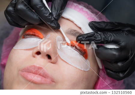 Caucasian woman undergoing eyelash lamination procedure. Caucasian woman undergoing eyelash lamination procedure. 132510560