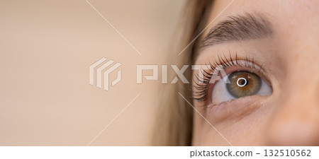 Close-up of a woman's eye after eyelash lamination procedure.  132510562