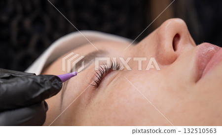 The process of professional eyelash lamination in a salon. The process of professional eyelash lamination in a salon. 132510563
