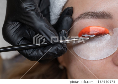 Caucasian woman undergoing eyelash lamination procedure.  132510573