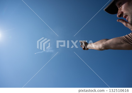 A man fires a flare gun with emergency fire. A man fires a flare gun with emergency fire. 132510616