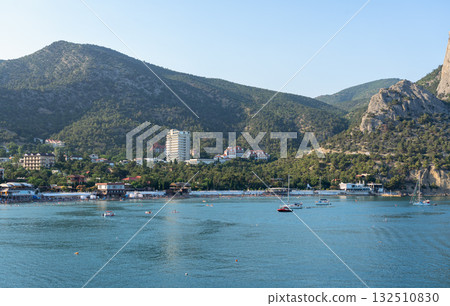 Crimean coast, Mount Sokol and yachts in the Novy Svet bay at sunrise 132510830