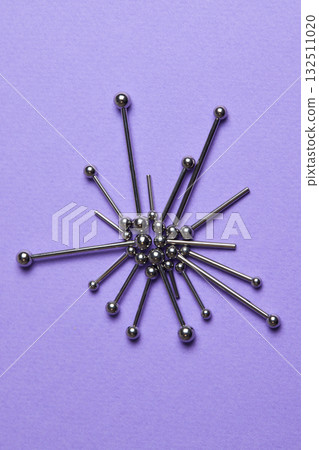 Piercing earrings close-up. On a Violet background. Piercing earrings close-up. On a Violet background. 132511020
