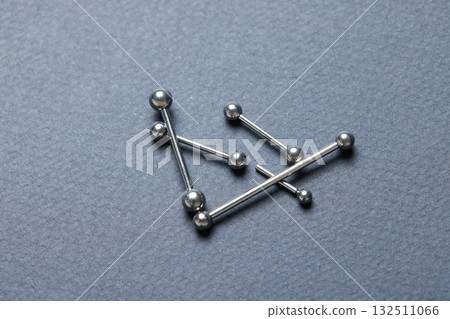 Piercing earrings close-up. On a black background. 132511066