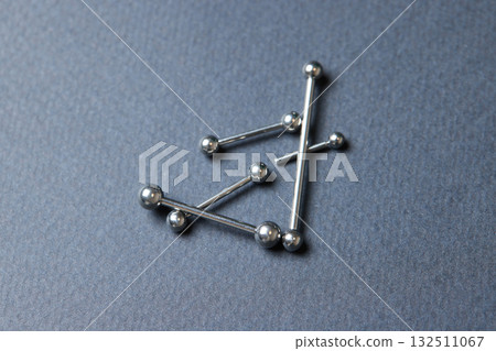 Piercing earrings close-up. On a black background. Piercing earrings close-up. On a black background. 132511067