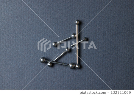 Piercing earrings close-up. On a black background. 132511069