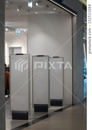 Radio-frequency security gates with integrated metal detector at a clothing store entrance Radio-frequency security gates with integrated metal detector at a clothing store entrance 132511084