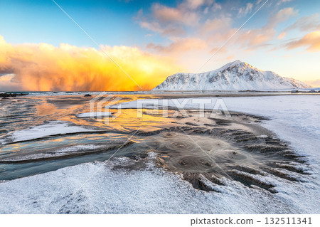 Amazing winter scenery on Skagsanden beach with illuminated clouds during sunrise 132511341