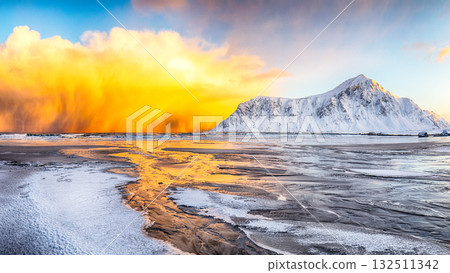 Amazing winter scenery on Skagsanden beach with illuminated clouds during sunrise 132511342