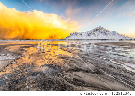 Astonishing winter scenery on Skagsanden beach with illuminated clouds during sunrise. Astonishing winter scenery on Skagsanden beach with illuminated clouds during sunrise. 132511343