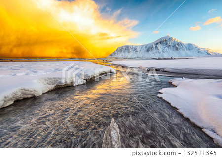 Amazing winter scenery on Skagsanden beach with illuminated clouds during sunrise 132511345