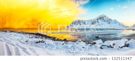 Amazing winter scenery on Skagsanden beach with illuminated clouds during sunrise 132511347
