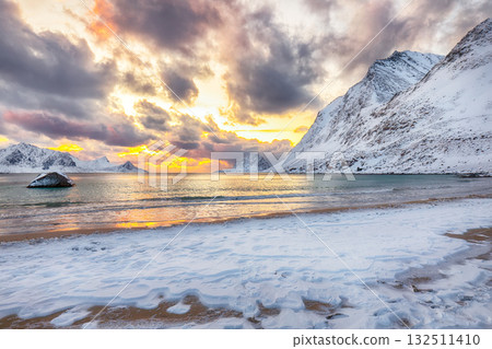 Unbeliveble winter view of Vik beach during sunset with lots of snow  and snowy  mountain peaks near Leknes. 132511410