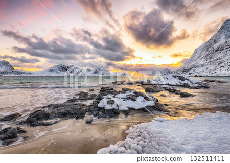 Amazing winter view of Vik beach during sunset with lots of snow  and snowy  mountain peaks near Leknes. 132511411