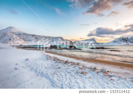 Unbeliveble winter view of Vik beach during sunset with lots of snow  and snowy  mountain peaks near Leknes. 132511412