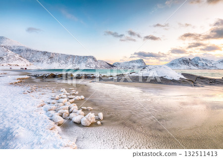 Stunning winter scenery with Haukland beach during sunset and snowy  mountain peaks near Leknes. 132511413
