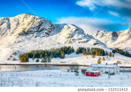 Amazing  winter view on Selfjorden with small fishing houses (rorbu) and snowy peaks on background. 132511415