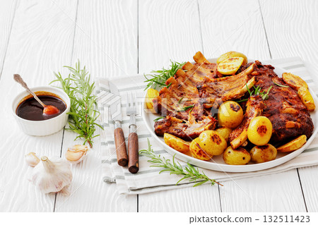 bbq baby pork ribs with potatoes, fresh rosemary bbq baby pork ribs with potatoes, fresh rosemary 132511423