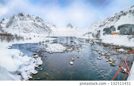 Dramatic winter scene of Kartfjorden on Vestvagoy island with snowy mountain peaks on Lofoten Islands . Dramatic winter scene of Kartfjorden on Vestvagoy island with snowy mountain peaks on Lofoten Islands . 132511431